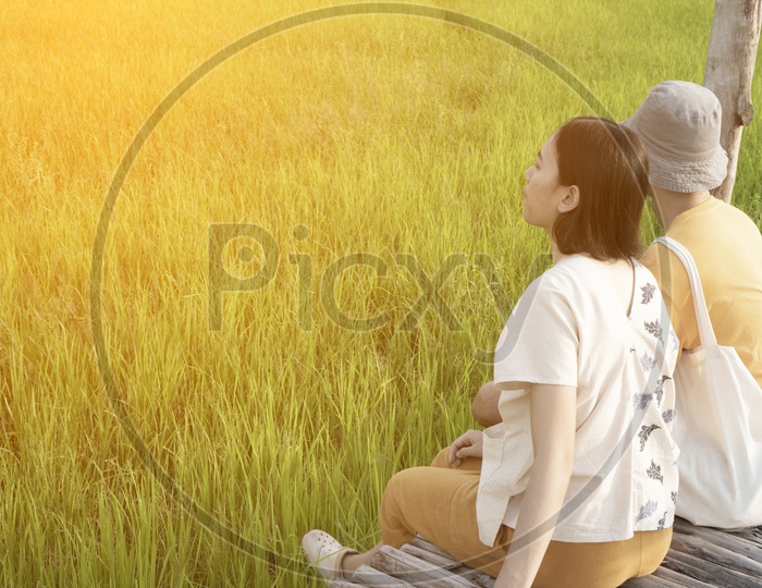 Couple Enjoying Fresh Air At Paddy Fields Or Rice Fields