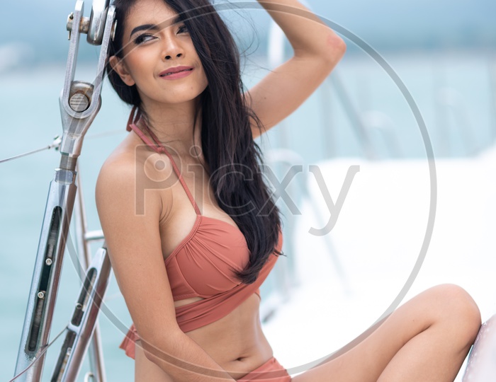 Young girl in bikini, yacht trip in summer
