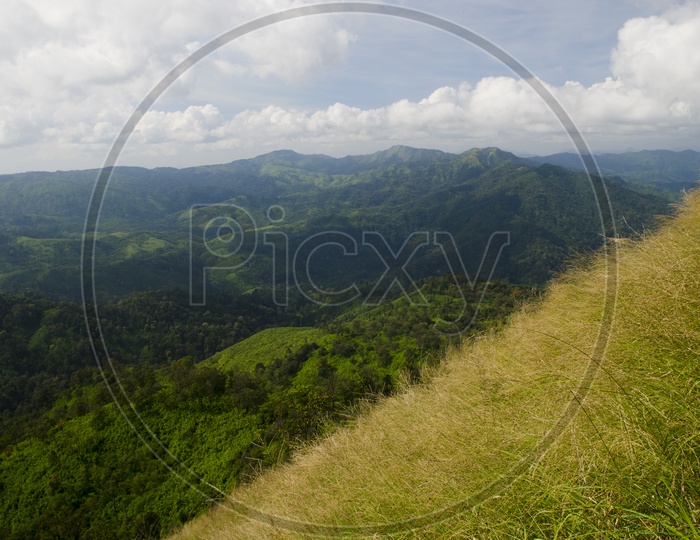 A Landscape With Green Mountains And Sky With Cotton Clouds at Khao Chang Phueak Pilok