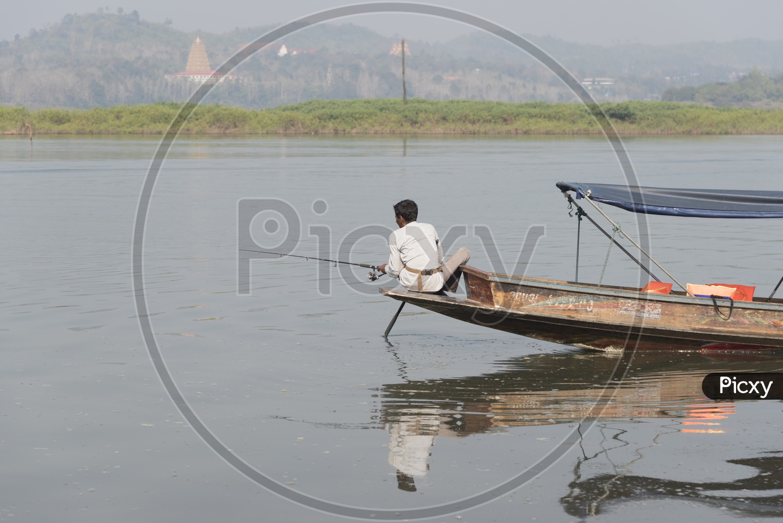 A fisherman Catching  Fish from Boat