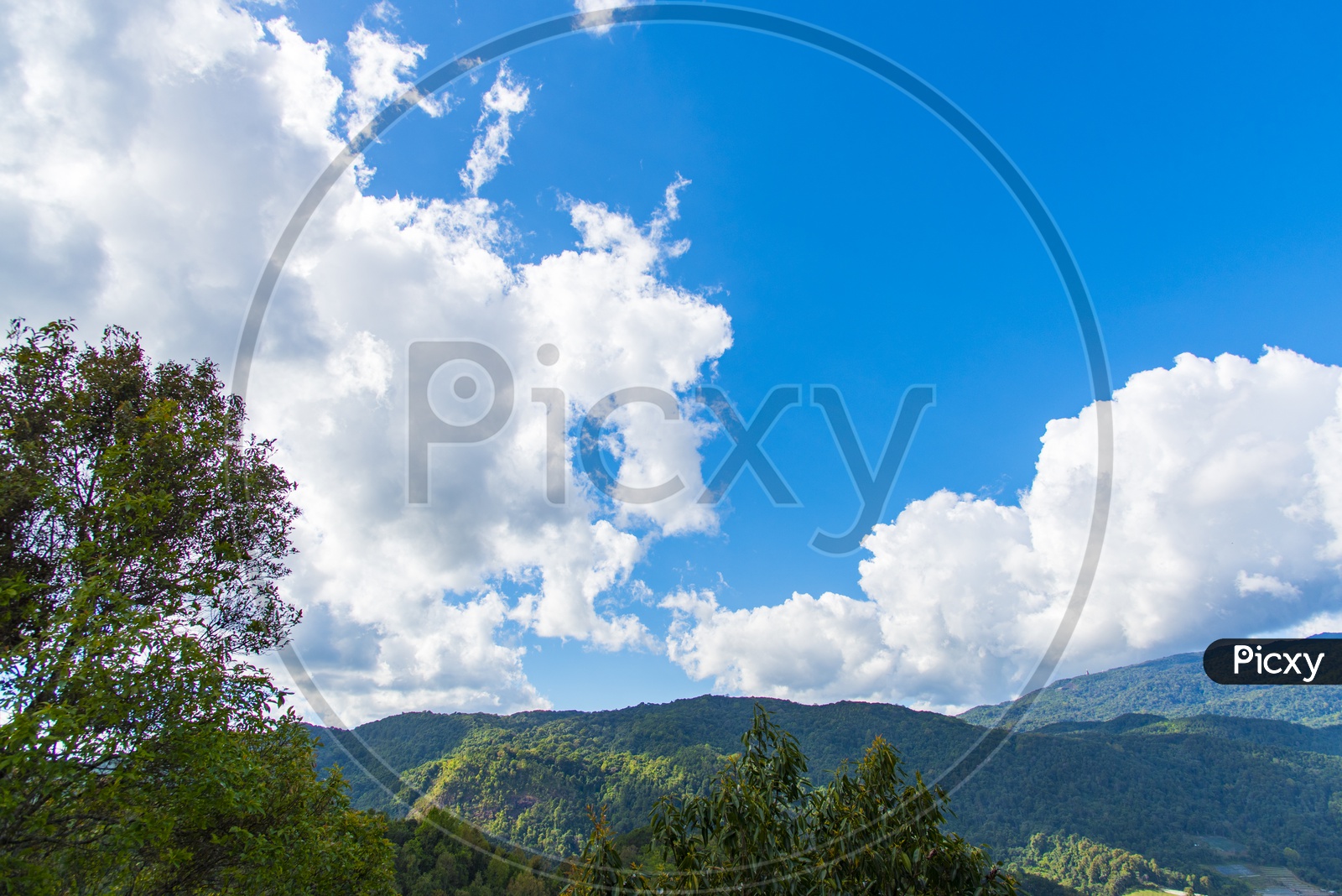 Nature Landscape With Foggy Clouded Mountains With Blue Sky Backdrop