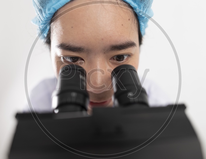 Researcher  using  a microscope in a laboratory