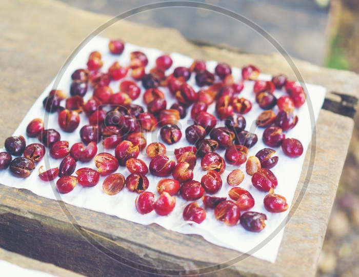 Red cherry coffee beans drying in the sun