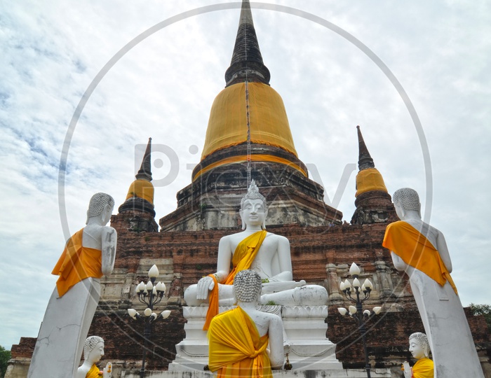 Ancient Buddha Statues  and Pagoda in Wat Yai Chai Mongkol at Ayutthaya in Thailand