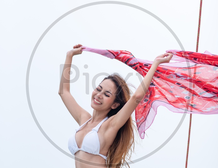 Beautiful Woman Or Asian Girl Holding Red Scarf  And Posing In a Bikini Wear