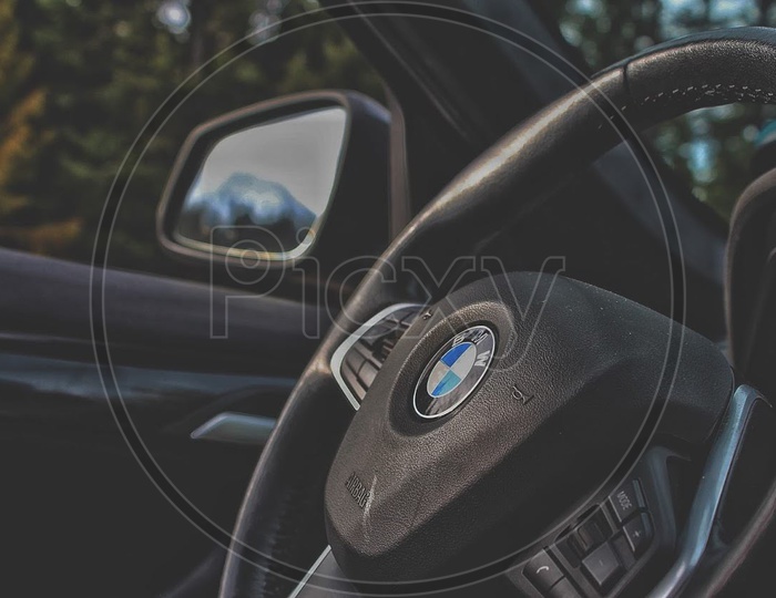 BMW Steering Wheel with mirror in the background