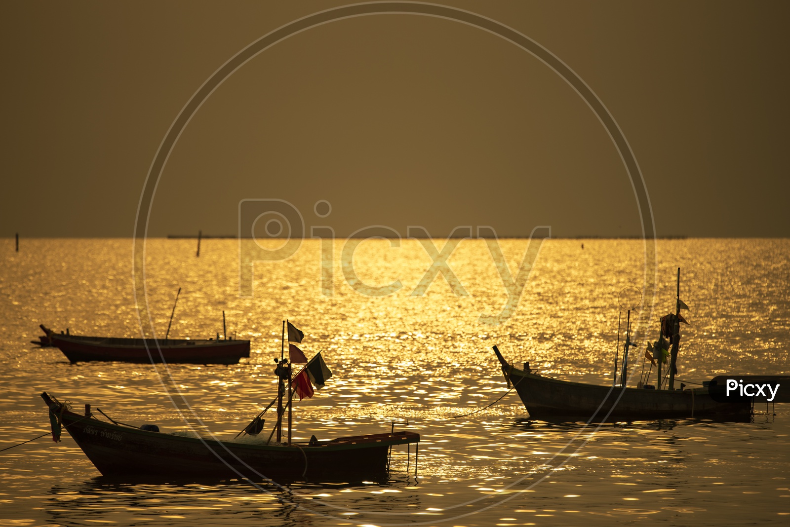 Local fishing boats on Sea in Sunset Backdrop