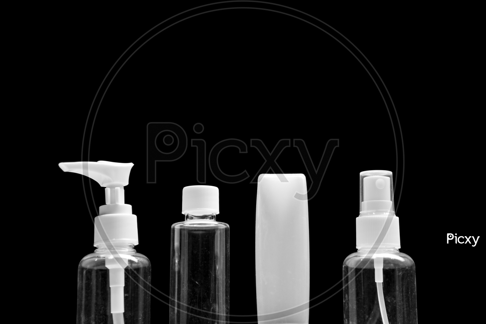 Empty cosmetic bottles isolated on black background