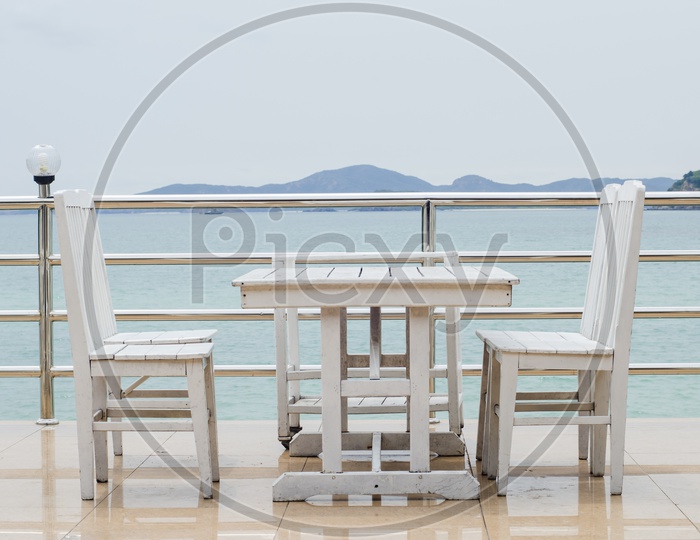 Dining table on a beach close to the ocean