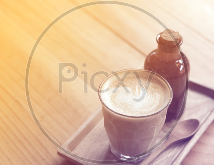 Coffee latte in a Glass  on wooden table Background With Vintage Filter