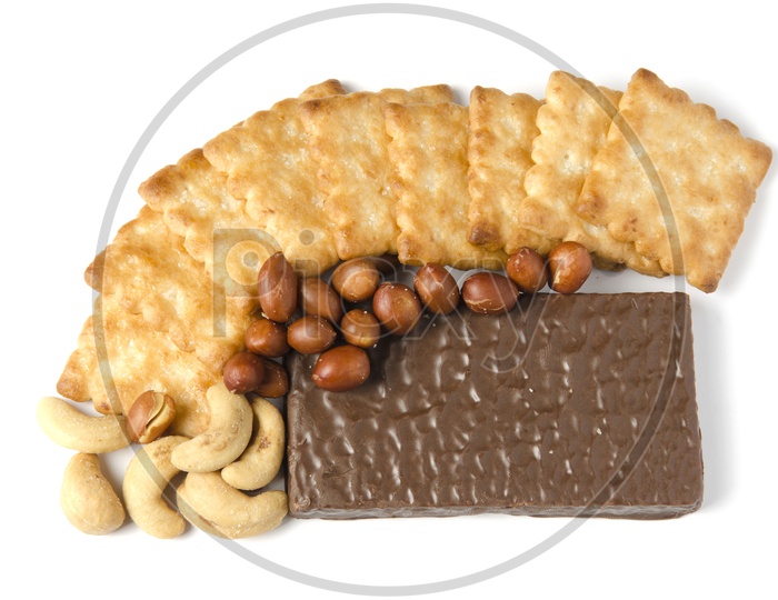 Chocolate Cake, Peanuts, Cashews and Biscuits Isolated on White Background
