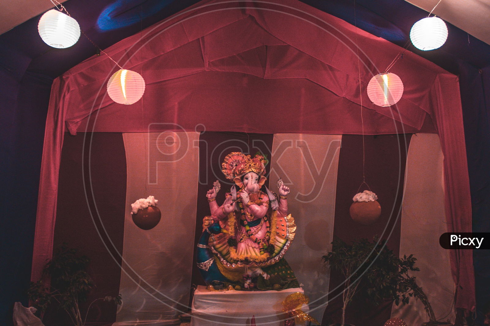 Ganesha idol in between lights