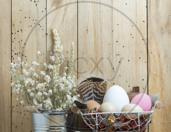 Easter Background With Eggs In a Basket Over Wooden Background