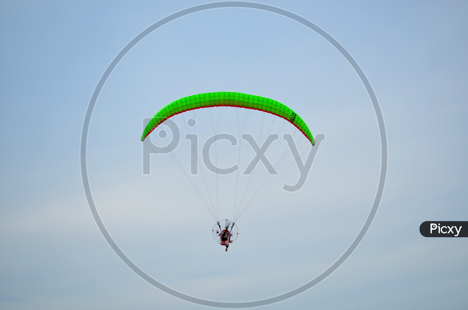 Moto paraglider Flying In Sky Over Sea