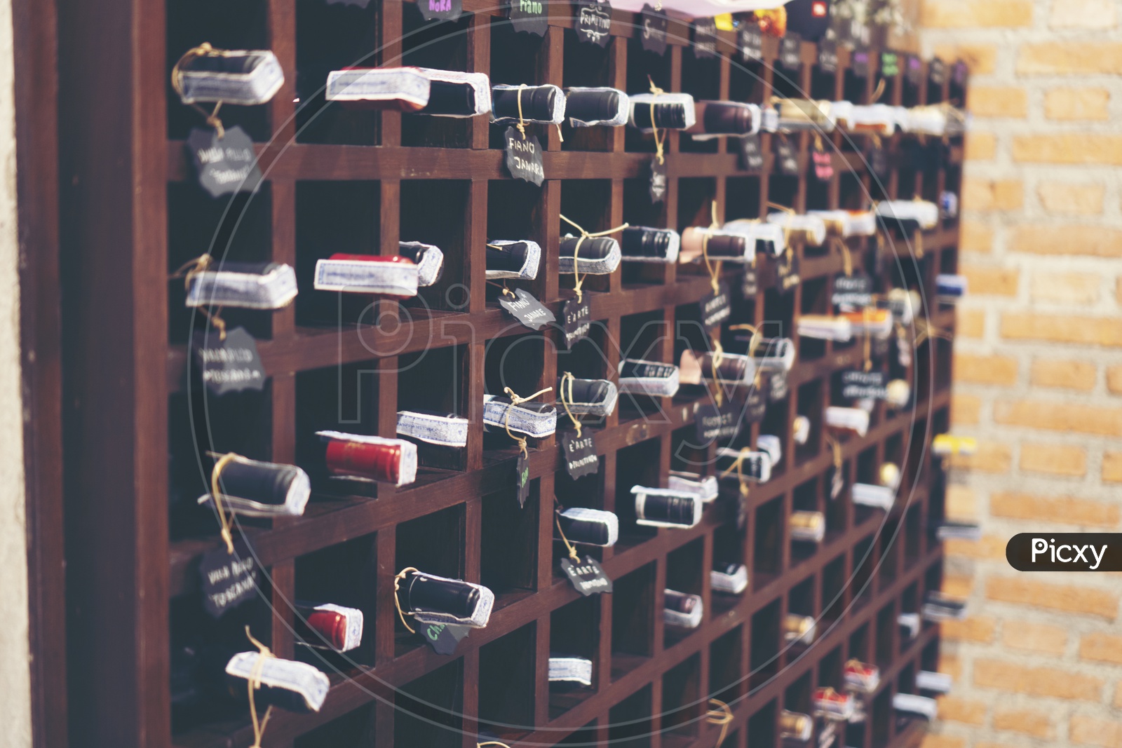 wine bottles stacked on wooden racks in cellar Closeup Forming a Background