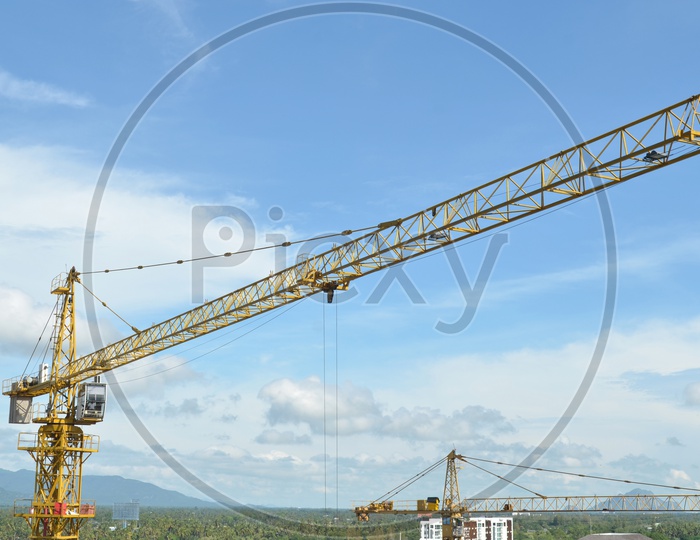 A View of Heavy Crane and building working progress At construction site