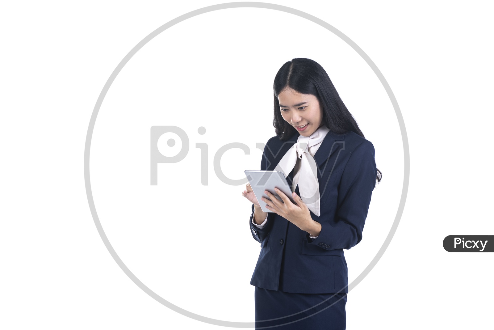 Excited Business woman in a suit using a digital tablet on isolated background