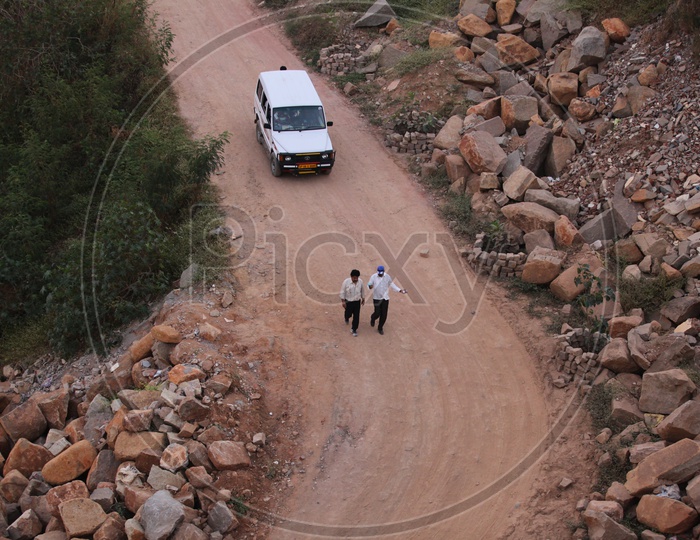 Indian Men walking alongside the quarry road