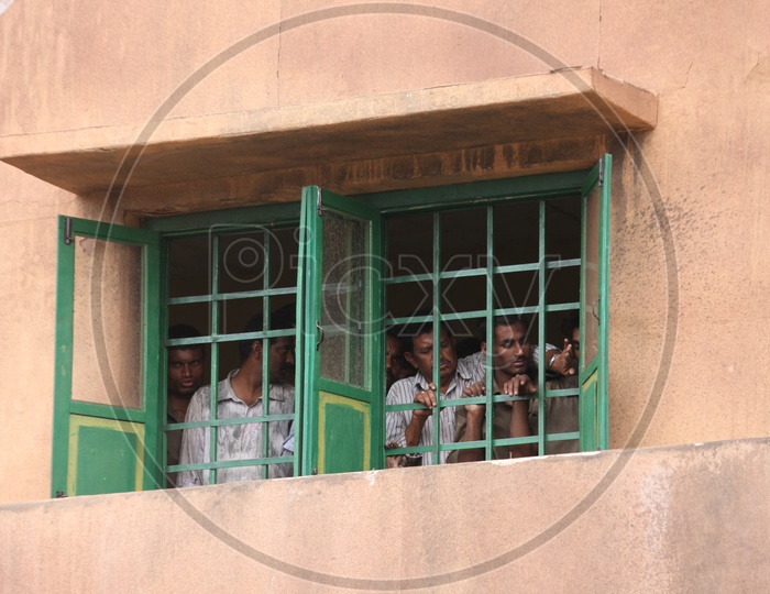 Indian Men peeping through the windows