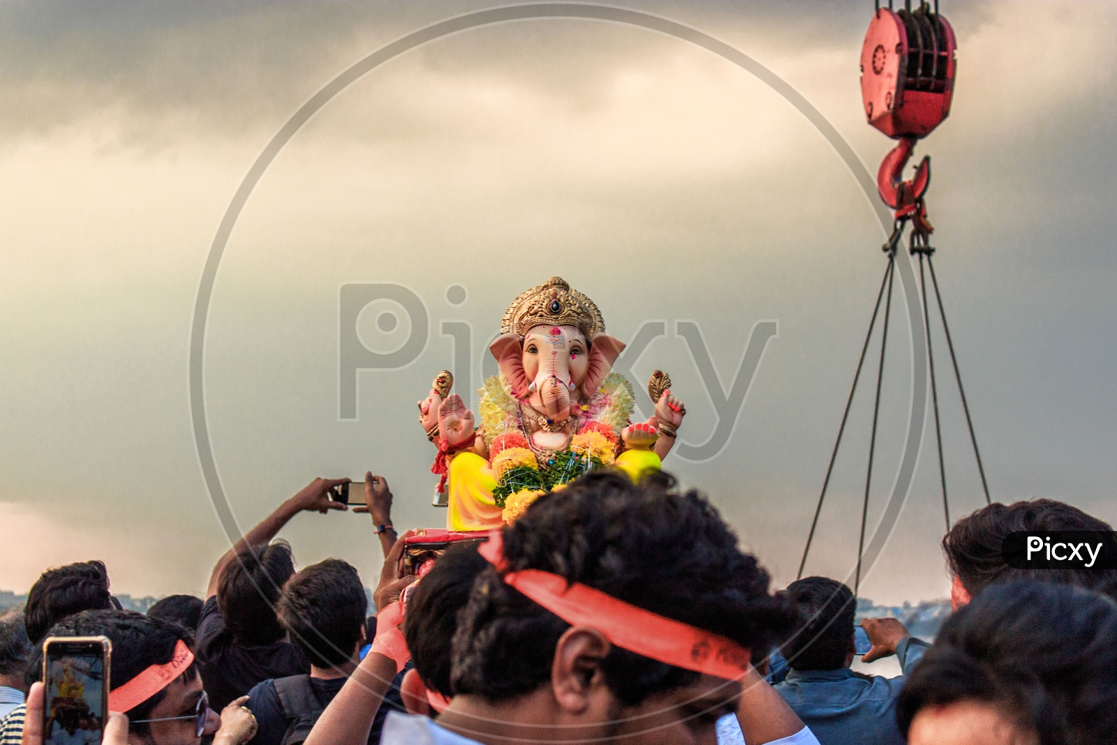 person carrying ganesha idol on his head