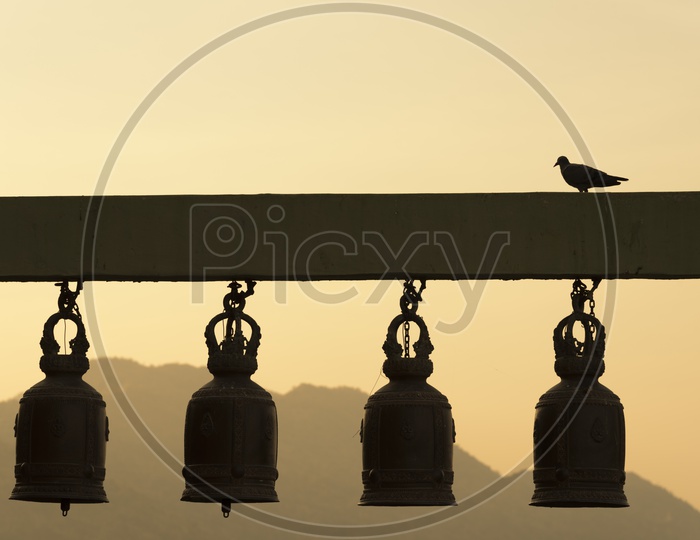 Thai Temple Bells With Sunset Sky Backdrop