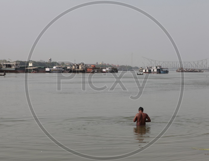 Indian Man taking a dip in Hooghly River