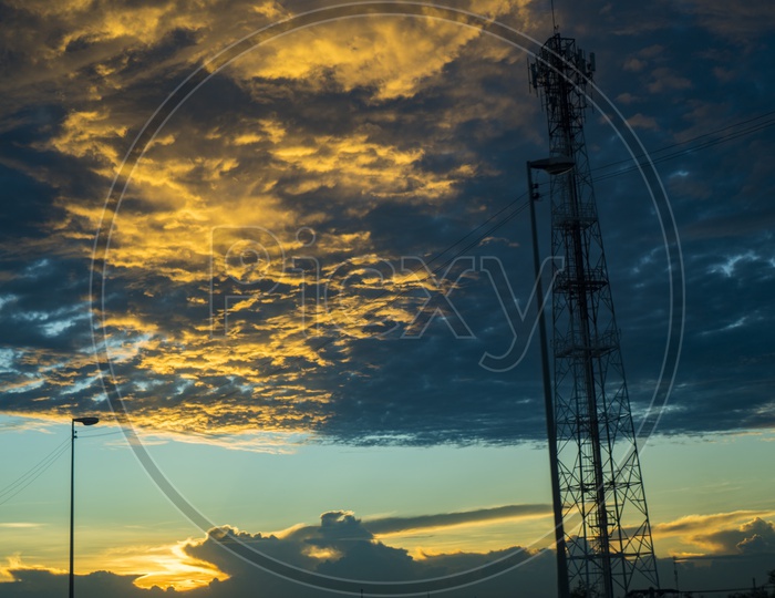 Silhouette of Tele network Tower Over a Sunset Sky