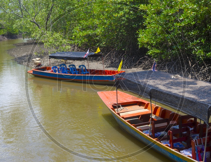 Boats on Muddy River Mouths At Mangrove Forests
