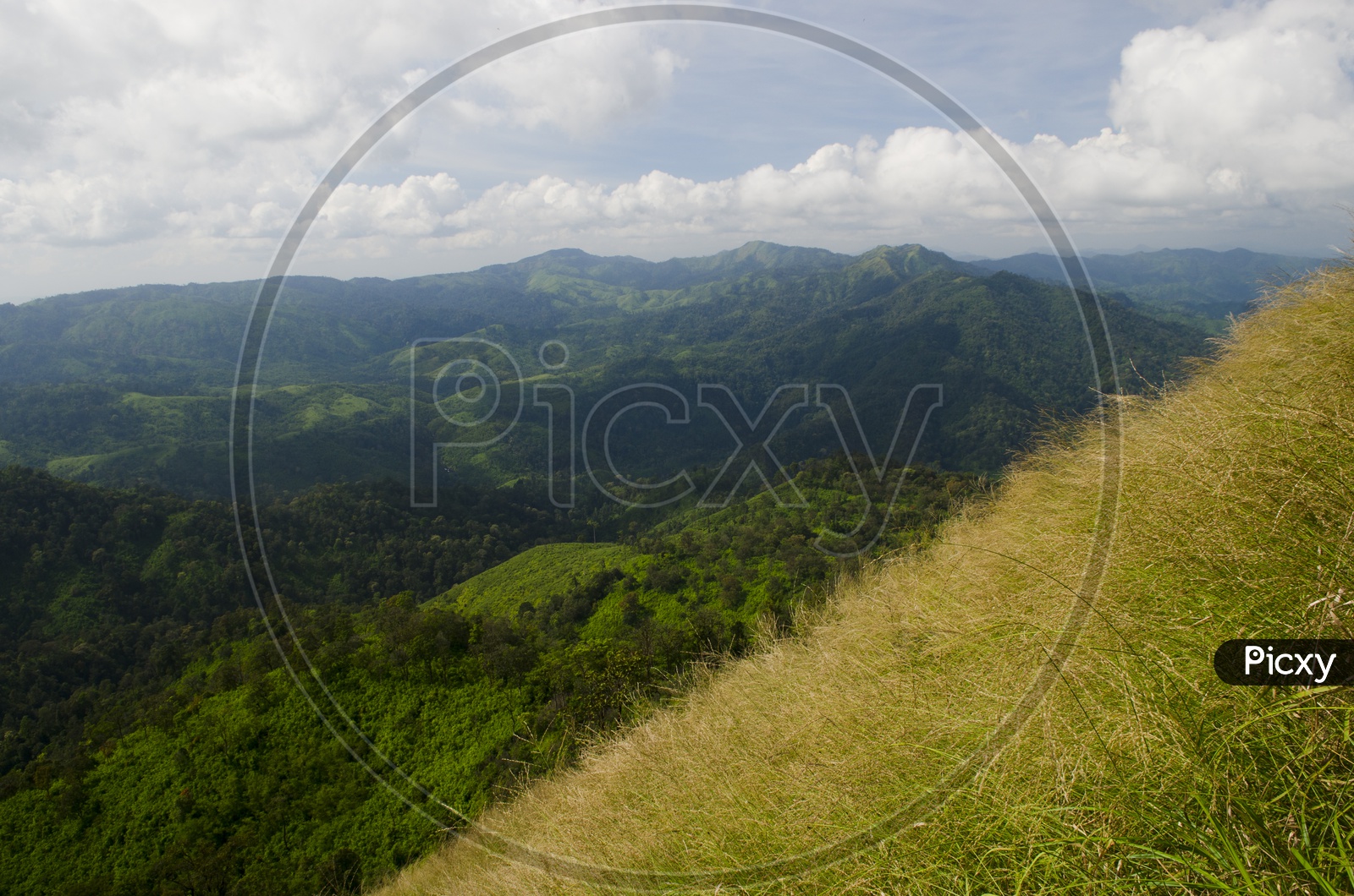 A Landscape With Green Mountains And Sky With Cotton Clouds at Khao Chang Phueak Pilok