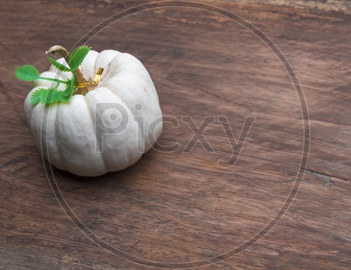White raw pumpkin on wooden table background