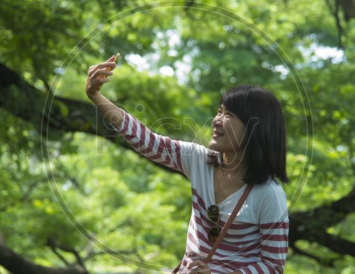 Thai Girl Taking selfie In nature