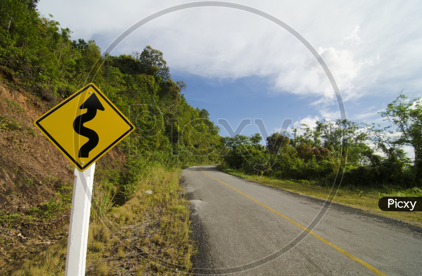 Zig-zag  Road Sign Or Warning  Board in a Terrain Or Ghat  Road
