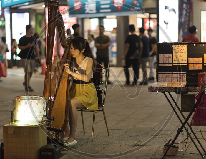 Artists Playing Camac Harps  on The Streets Market Of Taipei Downtown City Of Taiwan