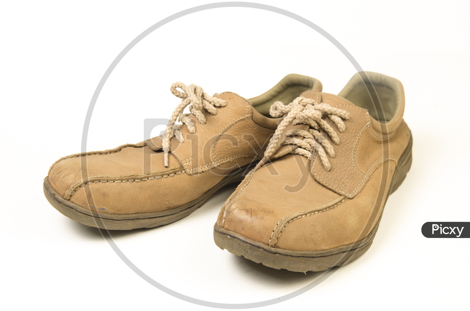Brown leather men's shoes with wooden shoe stretchers on the side
