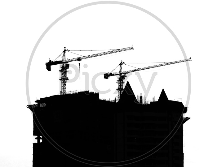 Silhouette Of High Rise under Construction  Building  With Heavy Cranes