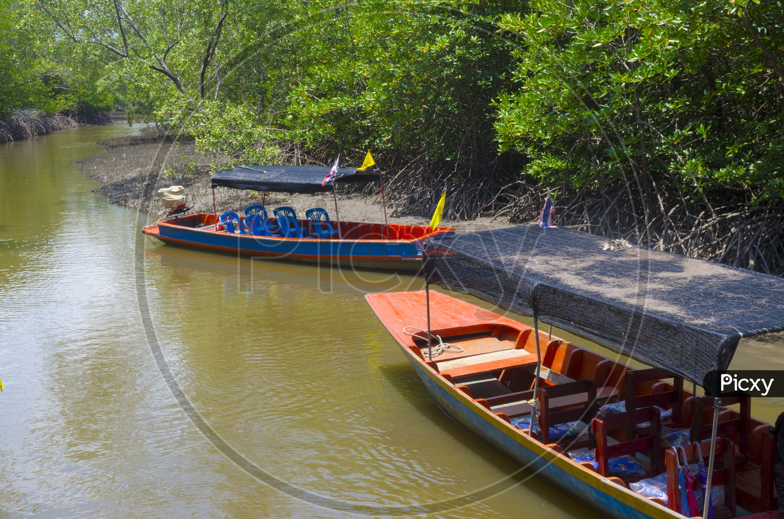 Boats on Muddy River Mouths At Mangrove Forests