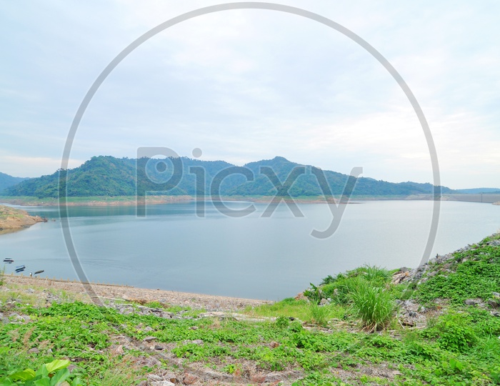 Lake with Mountains in Background in Thailand