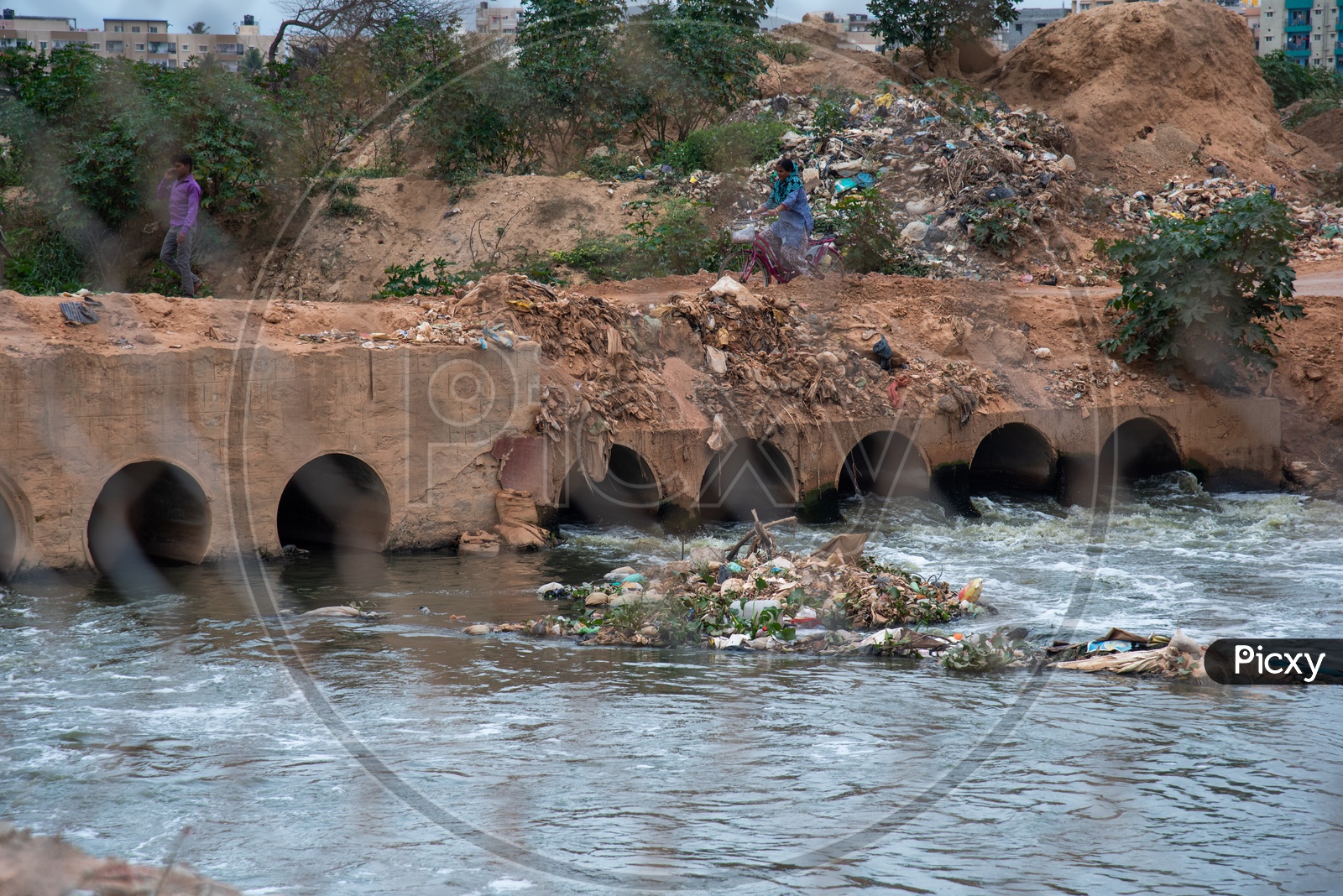Plastic Or Garbage in Water Channel  With a Bridge