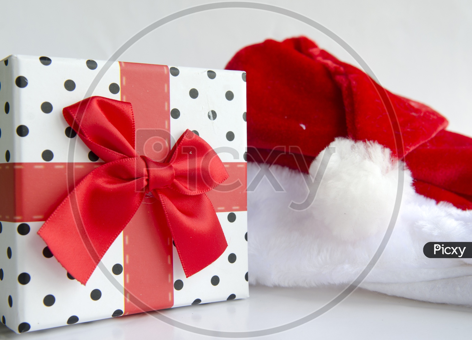 Santa Cap  with Gift Box For Christmas On an Isolated White Background