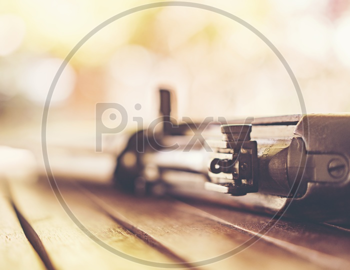 Ancient Machine Gun Used in World War II  On Wooden Background  With  Selective Focus