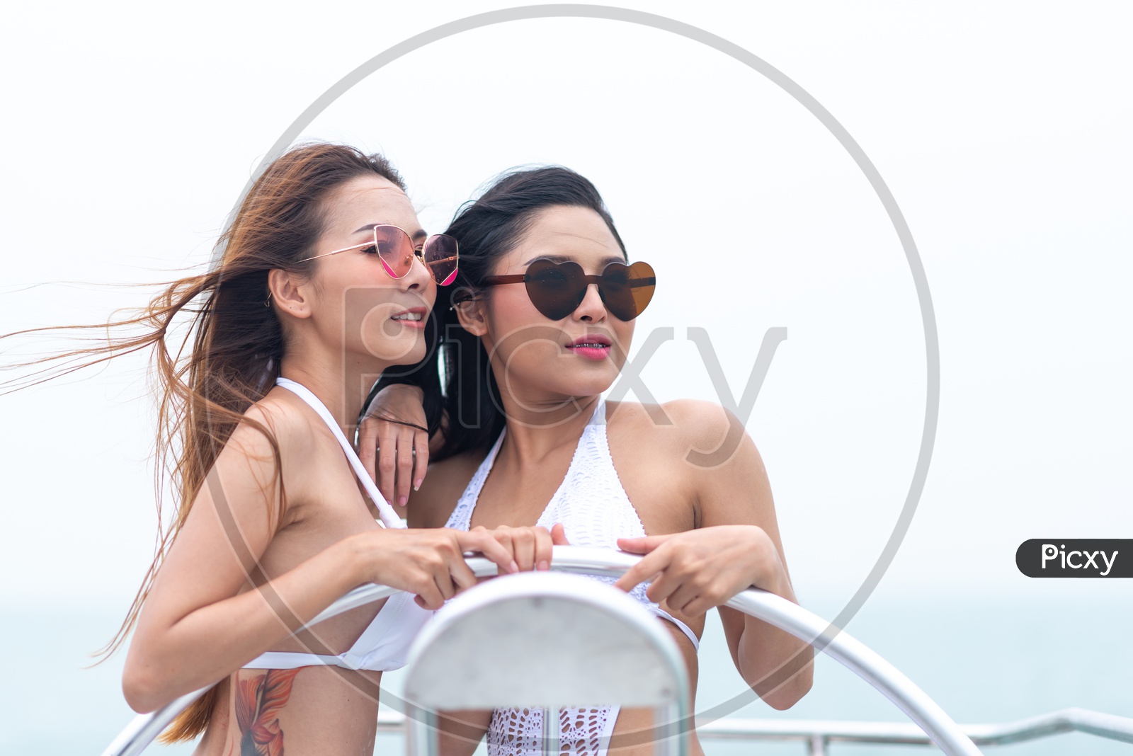 Woman or Asian Girls Posing In Bikinis At A Yacht Party Wearing Bikini