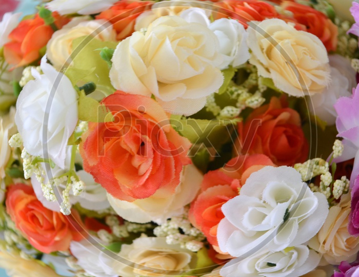Colourful Artificial Flowers Closeup Forming a Background