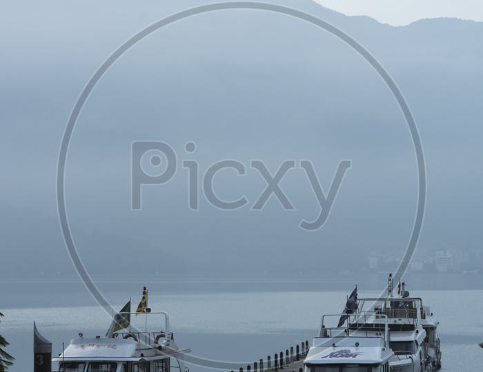 Tourist boats docking in peaceful morning at Shuishe Pier, Sun Moon Lake, Taiwan.