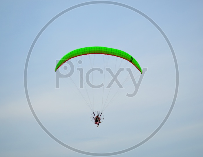Moto paraglider Flying In Sky Over Sea