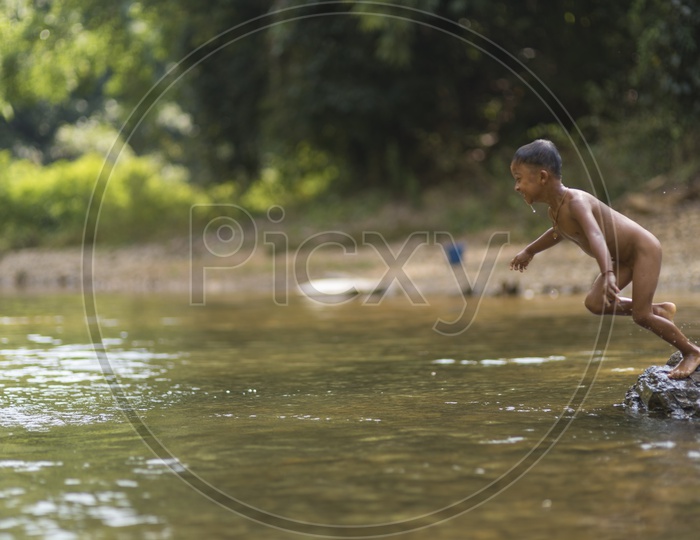 Young Child  Diving into Water Happily