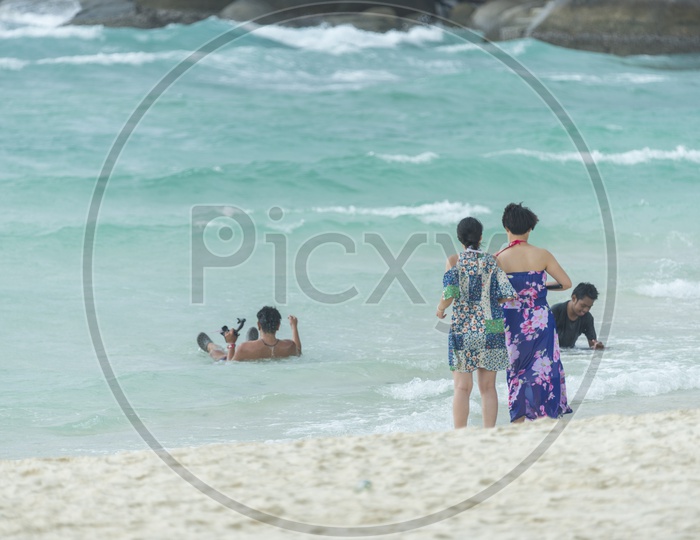Tourists Enjoying Swimming At Phuket Beach