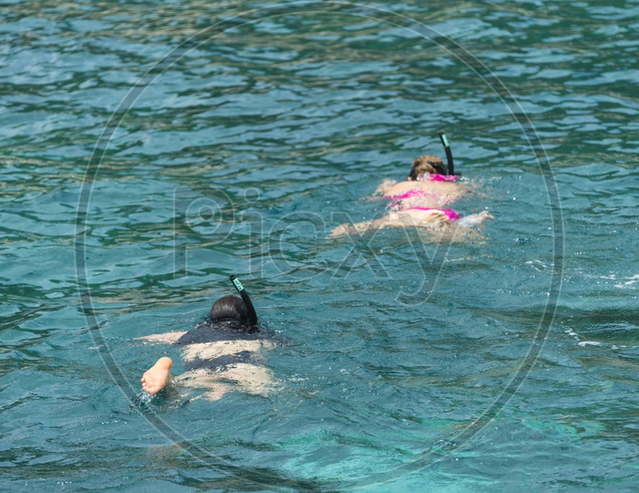Tourists Wearing Bikinis And Swimming In Sea At Phuket