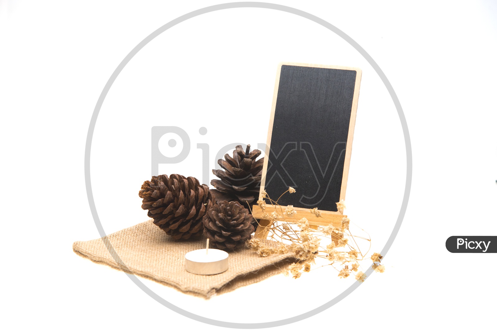 Blackboard, pine cone and candles