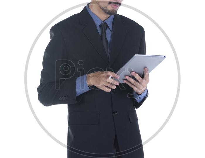 handsome man in a suit using a digital tablet on isolated background
