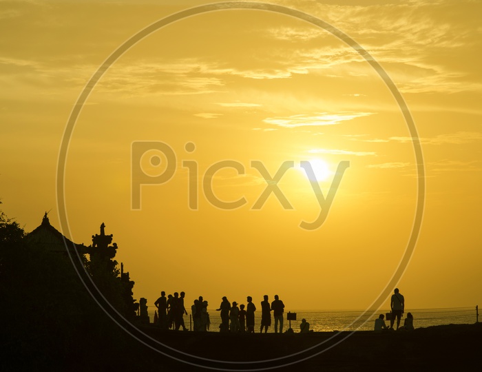 Silhouette of Group of  people At a Beach  With Sunset Sky in Background